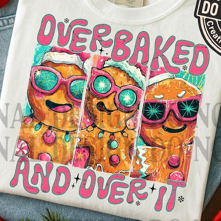 White t-shirt with colorful cupcake design and text 'OVERBAKED AND OVER IT'